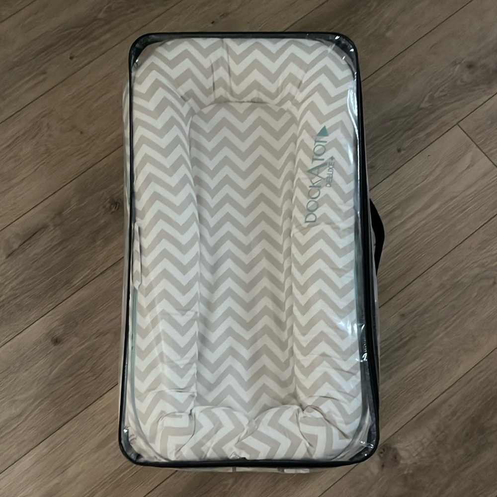 Dockatot like new, still in packaging.  Baby tried it once and didn’t like it.